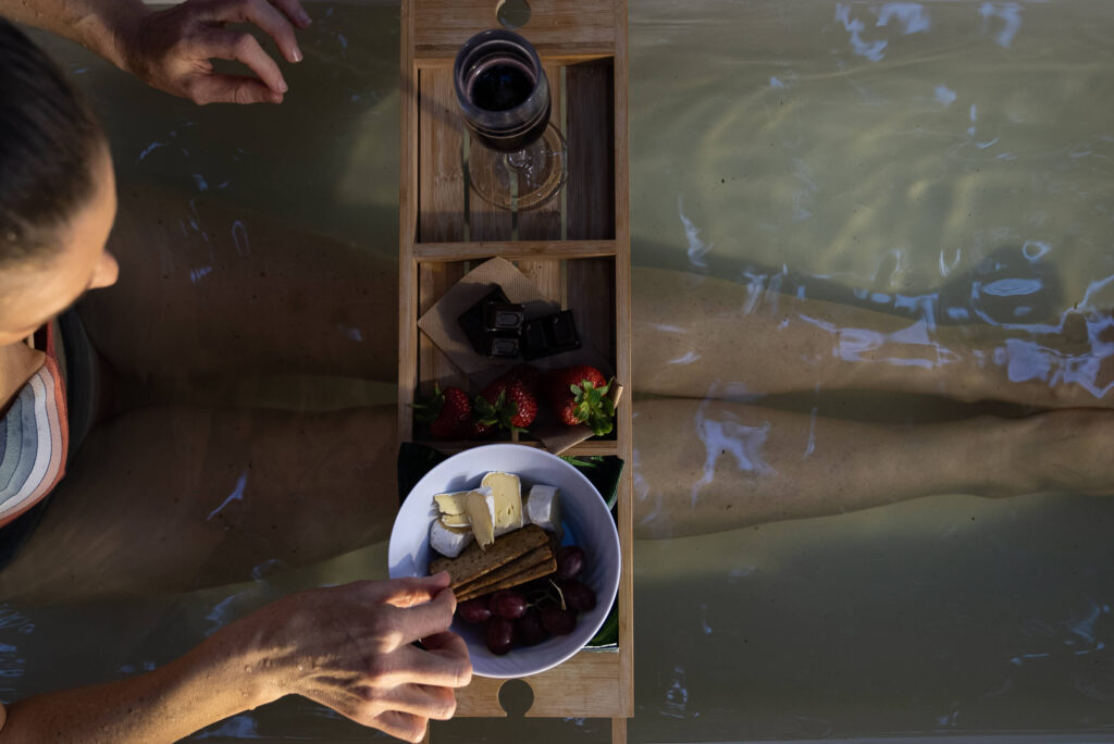 women in a outdoor bath in Invercargill with snacks