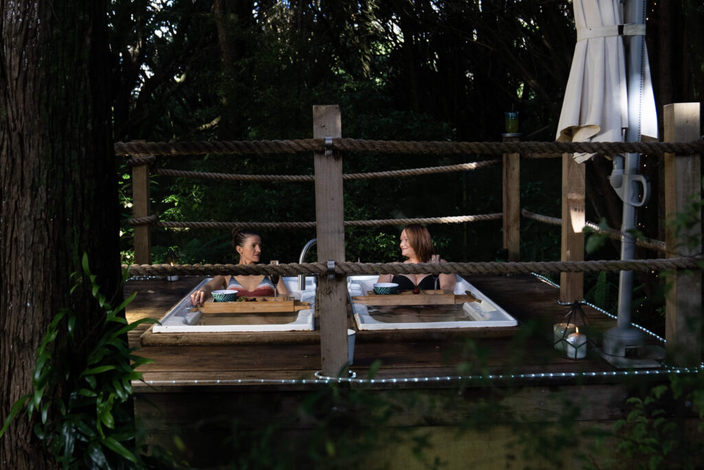 two friends enjoying a soak in invercargill hot baths